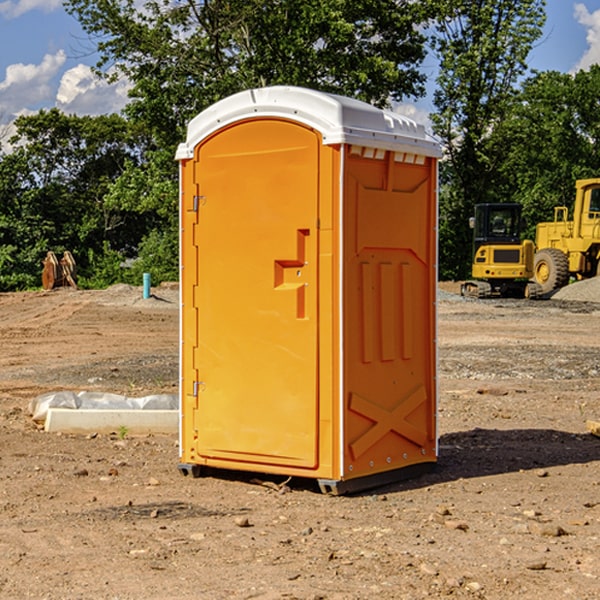 what is the cost difference between standard and deluxe portable restroom rentals in Mills